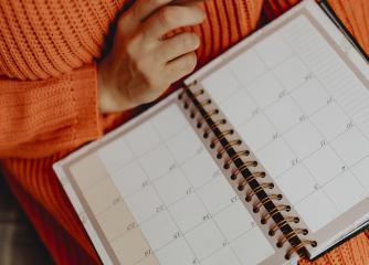 Person skriver i kalender